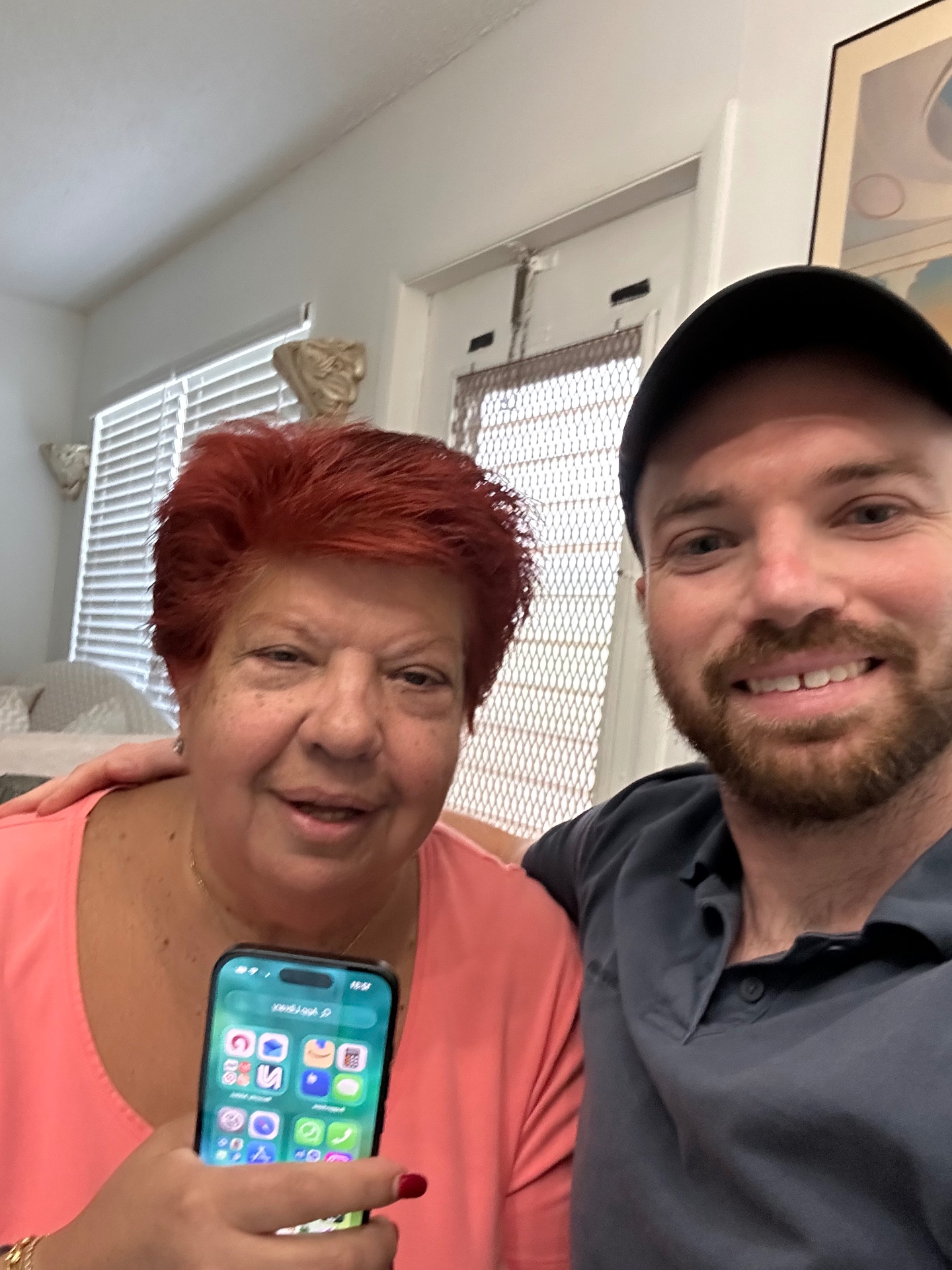 Austin with a smiling student holding her iPhone after a lesson